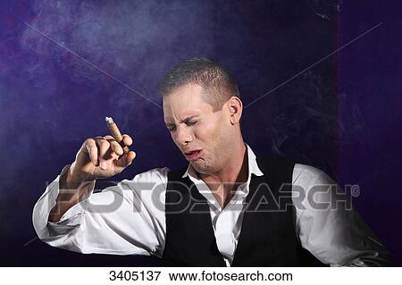 Stock Photo - Man holding a cigar and coughing . Fotosearch
