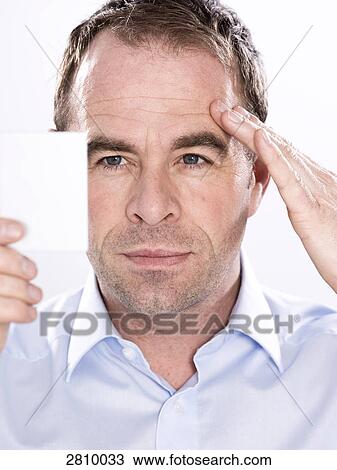 Man holding hand mirror and examining his face View Large Photo Image Stock Image - Man holding hand mirror and examining his face . Fotosearch