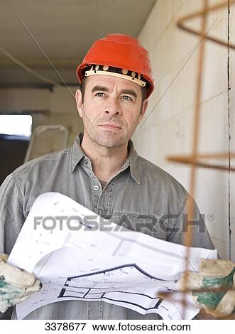 Man holding plan on construction site, low angle view View Large Photo Image Stock Photo - Man holding plan on construction site, low angle view . Fotosearch