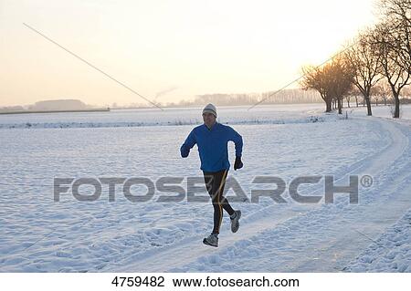Man jogging in snow, Tannheimer Tal, Tyrol, Austria View Large Photo Image Stock Image - Man jogging in snow, Tannheimer Tal, Tyrol, Austria . Fotosearch