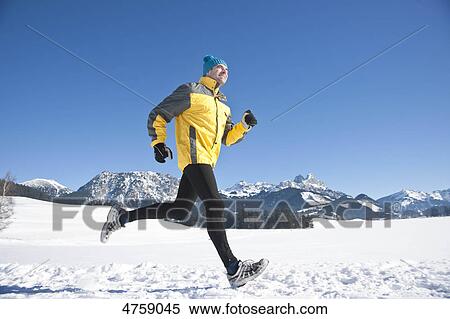 Man jogging in snow, Tannheimer Tal, Tyrol, Austria View Large Photo Image Stock Photography - Man jogging in snow, Tannheimer Tal, Tyrol, Austria . Fotosearch
