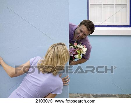 Man looking at woman behind wall View Large Photo Image Stock Image - Man looking at woman behind wall . Fotosearch