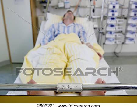 Stock Image - Man lying in hospital bed . Fotosearch