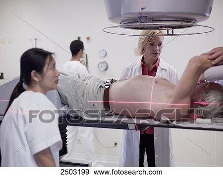 Stock Photo - man lying under a x-ray . Fotosearch