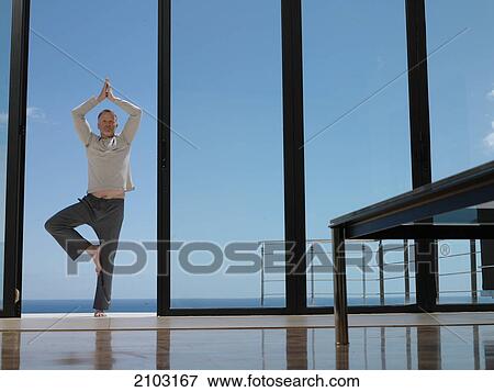 Man meditating at balcony View Large Photo Image Stock Photo - Man meditating at balcony . Fotosearch