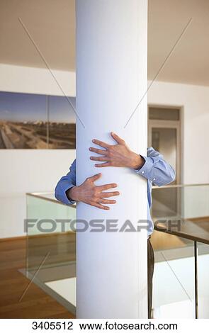 Man standing behind column View Large Photo Image Stock Image - Man standing behind column . Fotosearch
