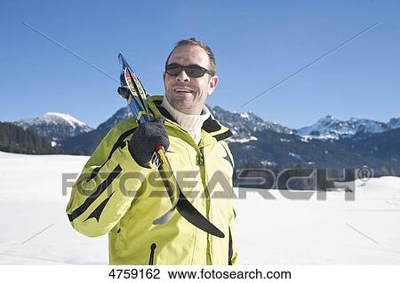 Man with skis in winter landscape, Tannheimer Tal, Tyrol, Austria View Large Photo Image Stock Image - Man with skis in winter landscape, Tannheimer Tal, Tyrol, Austria . Fotosearch