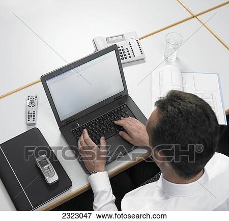 Stock Photo - Man working on laptop . Fotosearch