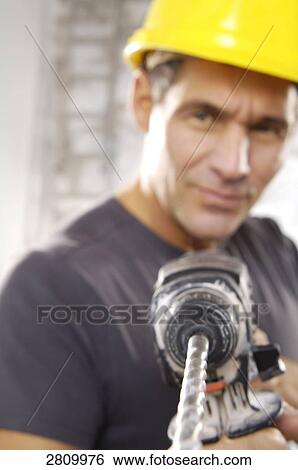 Manual worker holding hand drill View Large Photo Image Stock Photograph - Manual worker holding hand drill . Fotosearch