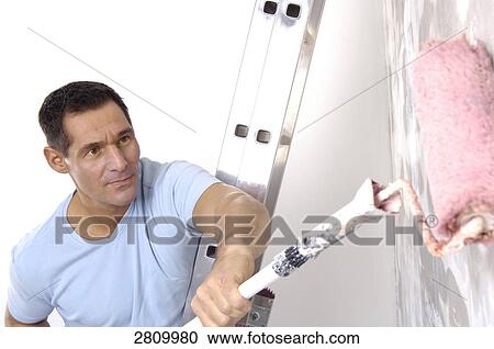 Manual worker painting wall with paint roller View Large Photo Image Stock Image - Manual worker painting wall with paint roller . Fotosearch