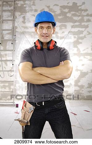 Picture - Manual worker standing with his arms crossed . Fotosearch