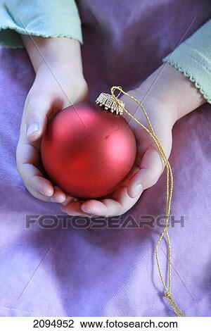Mid section view of girl holding Christmas bauble View Large Photo Image Stock Image - Mid section view of girl holding Christmas bauble . Fotosearch