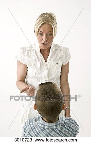 Mother advising her son, studio shot View Large Photo Image Stock Image - Mother advising her son, studio shot . Fotosearch