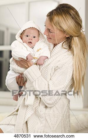 Stock Image - Mother holding baby . Fotosearch
