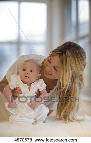 Mother holding baby View Large Photo Image Stock Photo - Mother holding baby . Fotosearch