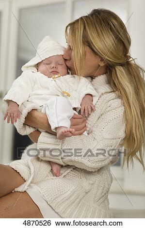 Stock Photograph - Mother kissing baby . Fotosearch