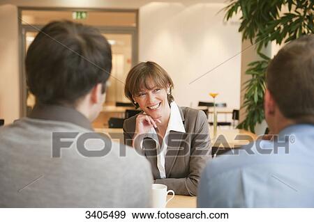 Stock Photo - One woman and two men having a break . Fotosearch