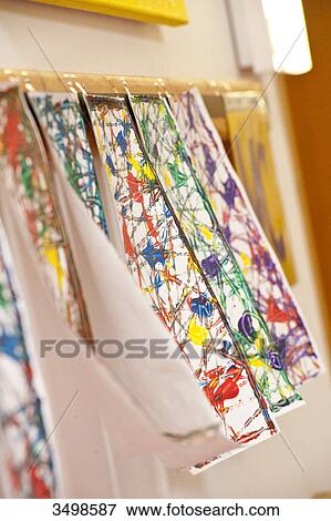 Paintings hanging to dry, close-up View Large Photo Image Stock Photo - Paintings hanging to dry, close-up . Fotosearch
