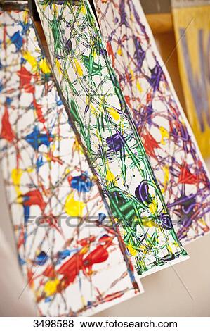 Stock Photo - Paintings hanging to dry, close-up . Fotosearch