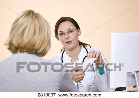 Stock Photo - Patient consulting with female doctor . Fotosearch