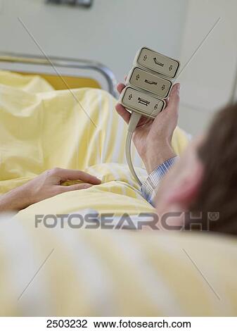 Patient holding bed controller View Large Photo Image Stock Image - Patient holding bed controller . Fotosearch