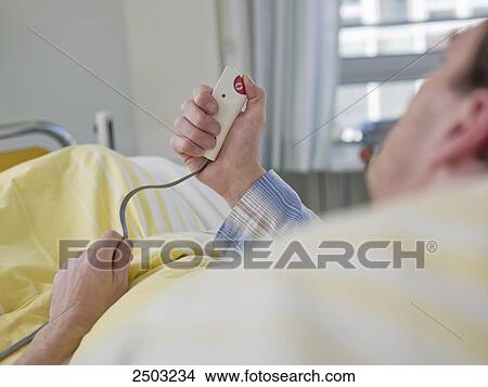 Patient pressing emergency call equipment View Large Photo Image Picture - Patient pressing emergency call equipment . Fotosearch