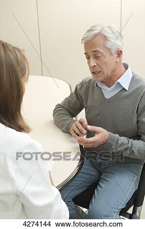 Patient talking to female doctor View Large Photo Image Picture - Patient talking to female doctor . Fotosearch