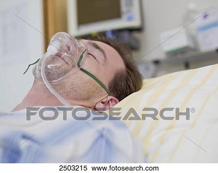 Patient wearing oxygen mask in hospital View Large Photo Image Stock Photography - Patient wearing oxygen mask in hospital . Fotosearch