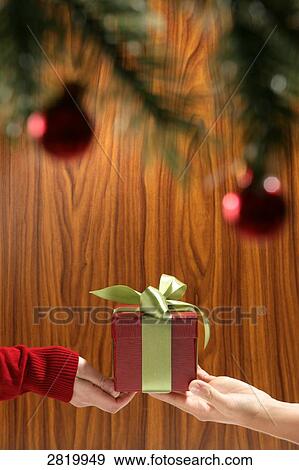 People's hands holding Christmas present View Large Photo Image Stock Photo - People's hands holding Christmas present . Fotosearch