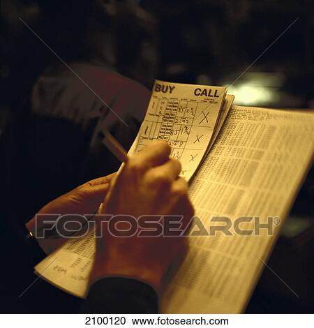 Stock Image - Person doing paperwork, New York Stock Exchange, New York City, New York State, USA . Fotosearch