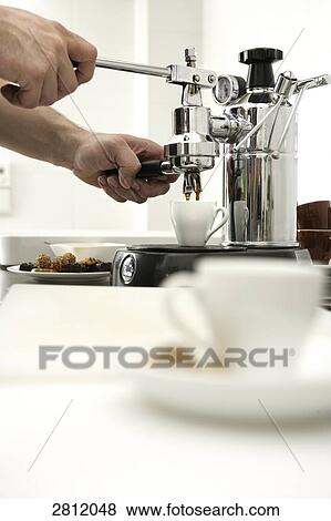 Stock Photo - Person making coffee with coffee maker . Fotosearch