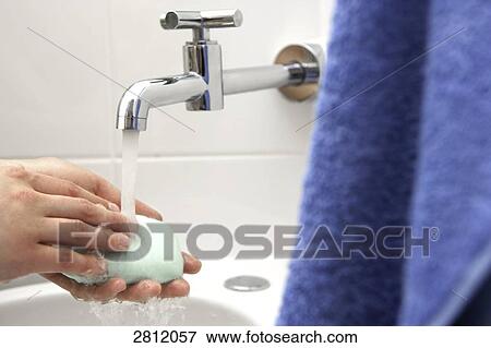 Person washing hands under faucet View Large Photo Image Stock Photo - Person washing hands under faucet . Fotosearch