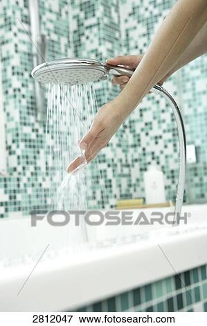 Person washing hands with shower in bathroom View Large Photo Image Stock Photo - Person washing hands with shower in bathroom . Fotosearch