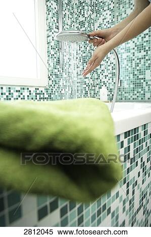 Stock Photography - Person washing hands with shower in bathroom . Fotosearch