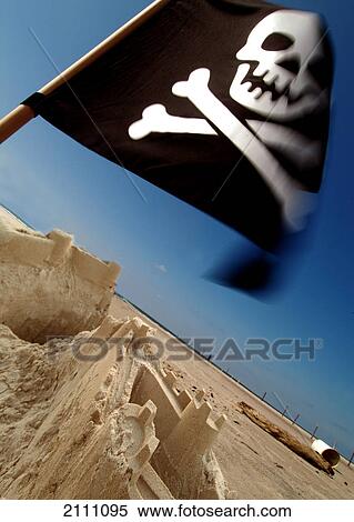 Pirate flag fluttering on beach View Large Photo Image Stock Photography - Pirate flag fluttering on beach . Fotosearch