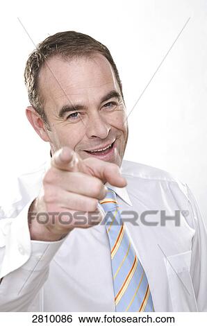 Portrait of businessman pointing and smiling View Large Photo Image Stock Photograph - Portrait of businessman pointing and smiling . Fotosearch