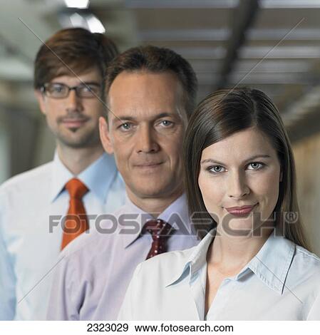 Portrait of businesspeople standing in row and smiling View Large Photo Image Stock Photo - Portrait of businesspeople standing in row and smiling . Fotosearch
