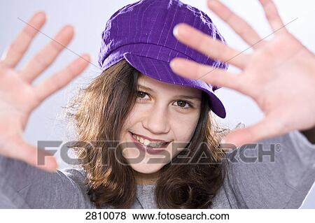 Stock Photo - Portrait of girl gesturing and smiling . Fotosearch