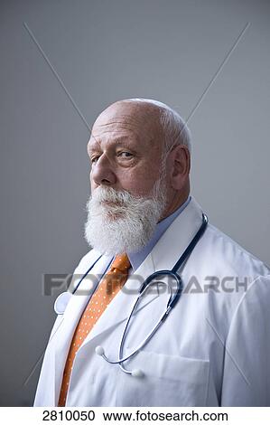 Portrait of male doctor with stethoscope in his neck View Large Photo Image Stock Image - Portrait of male doctor with stethoscope in his neck . Fotosearch