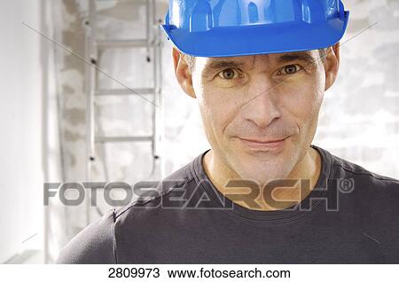 Stock Image - Portrait of manual worker smiling . Fotosearch