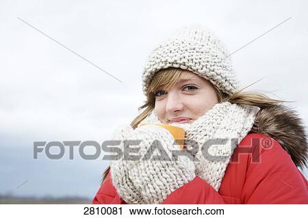 Portrait of teenage girl drinking hot chocolate in warm clothing View Large Photo Image Stock Image - Portrait of teenage girl drinking hot chocolate in warm clothing . Fotosearch
