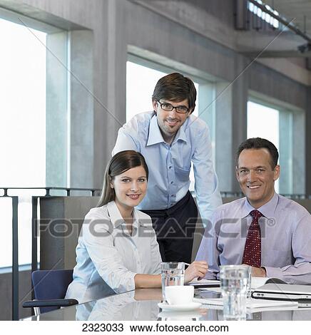 Portrait of three businesspeople smiling in meeting View Large Photo Image Stock Image - Portrait of three businesspeople smiling in meeting . Fotosearch