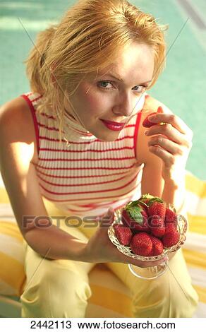 Portrait of woman eating strawberries View Large Photo Image Stock Image - Portrait of woman eating strawberries . Fotosearch