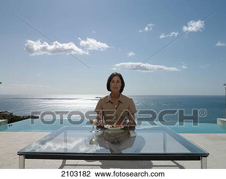 Portrait of woman having food at table View Large Photo Image Stock Image - Portrait of woman having food at table . Fotosearch