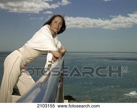 Stock Photography - Portrait of woman leaning on railing . Fotosearch