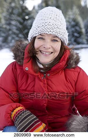 Stock Photo - Portrait of woman smiling in warm clothing . Fotosearch