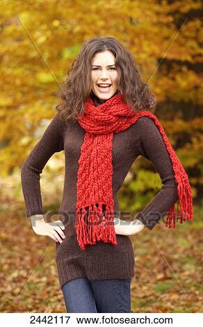 Portrait of woman standing with arms akimbo and smiling View Large Photo Image Stock Photo - Portrait of woman standing with arms akimbo and smiling . Fotosearch