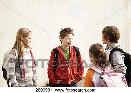 Primary school students discussing View Large Photo Image Stock Photo - Primary school students discussing . Fotosearch