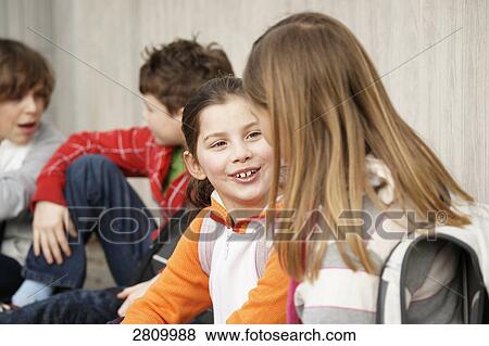 Primary school students discussing View Large Photo Image Stock Photo - Primary school students discussing . Fotosearch