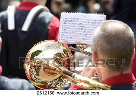 Stock Photo - Rear view of man playing trumpet . Fotosearch